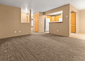 Thumbnail 22 of 73 - A spacious room with brown carpeting and beige walls at Graymayre Crossing Apartments, Spokane, WA, 99208