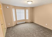 Thumbnail 26 of 73 - A room with a carpeted floor, a window with blinds, and a ceiling light at Graymayre Crossing Apartments, Spokane, WA, 99208