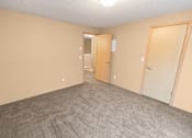 Thumbnail 28 of 73 - A room with carpeted floor and two doors at Graymayre Crossing Apartments, WA, 99208