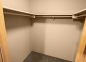 Thumbnail 29 of 73 - A small, empty closet with a grey carpeted floor at Graymayre Crossing Apartments, Spokane