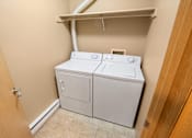 Thumbnail 30 of 73 - A white washer and dryer in a small laundry room at Graymayre Crossing Apartments, Spokane, WA, 99208