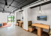 Thumbnail 19 of 63 - study or wfh space with tables and chairs and a tv