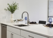 Thumbnail 5 of 63 - a kitchen with white cabinets and a sink and a white counter top