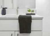 Thumbnail 10 of 63 - a white bathroom with a sink and a mirror