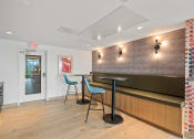 Thumbnail 26 of 63 - a bar with three stools in a room with a counter and a door