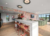 Thumbnail 25 of 63 - community room kitchen with a long white counter and chairs