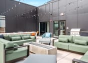 Thumbnail 29 of 63 - Deck with green couches and chairs and a table