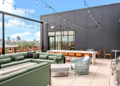 Thumbnail 33 of 63 - a rooftop patio with green couches and chairs and a table with chairs