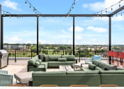 Thumbnail 34 of 63 - Rooftop deck with green couches and a view of a city from a balcony