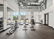 Thumbnail 35 of 63 - a fitness room with treadmills and other exercise equipment