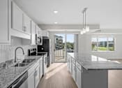 Thumbnail 27 of 39 - A modern kitchen with granite countertops and stainless steel appliances.