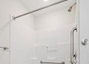 Thumbnail 39 of 39 - A white bathroom with a walk in shower.