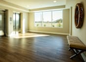 Thumbnail 19 of 22 - A room with a wooden floor and a bench.