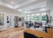 Thumbnail 6 of 6 - A modern living room with a wooden floor and furniture.