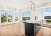 Thumbnail 59 of 63 - an open kitchen with a large island and a view of the city