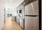 Thumbnail 47 of 63 - a kitchen with stainless steel appliances and white cabinets