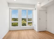 Thumbnail 53 of 63 - an empty living room with large windows and a door