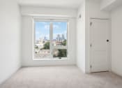Thumbnail 63 of 63 - an empty room with a large window and a door