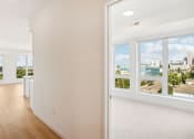 Thumbnail 57 of 63 - a view of a room with windows and a wall with four different signs on it