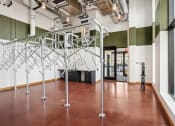Thumbnail 38 of 63 - a large room with white and green walls and a brown floor with bike storage