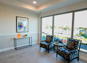 Thumbnail 8 of 13 - Two black patterned chairs are placed in a room with a large window.