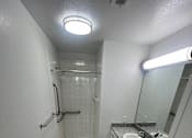 Thumbnail 14 of 22 - A bathroom with a toilet, sink, and shower.