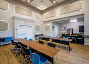 Thumbnail 2 of 11 - A conference room with a long table and chairs.