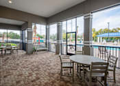 Thumbnail 7 of 11 - A patio with a table and chairs is shown.