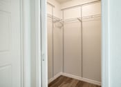 Thumbnail 15 of 30 - A white closet with a door open and shelves.
