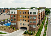 Thumbnail 3 of 13 - A modern apartment building with a pool in the backyard.