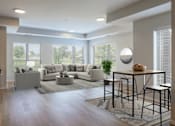 Thumbnail 12 of 13 - A modern living room with a large sectional sofa and a coffee table.