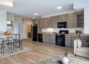 Thumbnail 6 of 13 - A modern kitchen with wooden floors and a black oven.