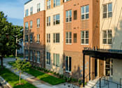 Thumbnail 2 of 13 - A multi-story apartment building with the name "VISTA 441" on the front.