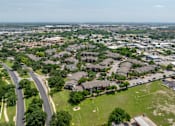 Thumbnail 15 of 35 - A bird's eye view of a residential area with houses and a road.
