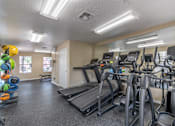 Thumbnail 29 of 35 - A gym with treadmills, elliptical machines, and other exercise equipment.