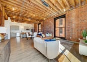Thumbnail 12 of 41 - a living room with wooden floors and exposed brick walls