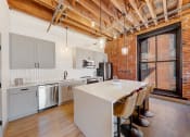 Thumbnail 6 of 41 - a kitchen with a white counter top and a large window