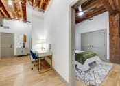 Thumbnail 8 of 41 - a bedroom with a bed and a desk with a chair