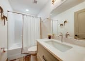 Thumbnail 27 of 41 - a bathroom with a shower and a sink and a toilet at Greeley Lofts, St. Louis, MO