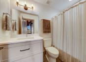 Thumbnail 25 of 41 - a bathroom with a shower and a toilet and a sink at Greeley Lofts, St. Louis, MO