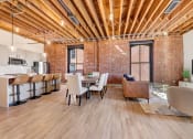 Thumbnail 14 of 41 - a living room and dining room with a table and chairs at Greeley Lofts, St. Louis, MO
