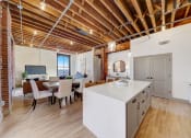 Thumbnail 18 of 41 - a kitchen with a large island and a dining room at Greeley Lofts, St. Louis