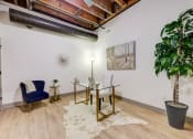 Thumbnail 24 of 41 - a conference room with a glass desk and a chair and a plant at Greeley Lofts, St. Louis, Missouri