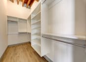 Thumbnail 29 of 41 - a walk in closet with shelves and a refrigerator
