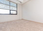 Thumbnail 39 of 58 - an empty living room with a window and white walls