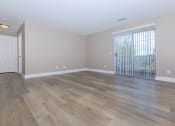 Thumbnail 3 of 31 - a bedroom with hardwood floors and a large window