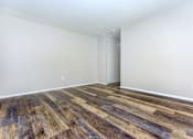 Thumbnail 6 of 23 - a bedroom with hardwood floors and white walls