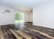 Thumbnail 2 of 23 - a living room with hardwood floors and a ceiling fan