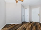 Thumbnail 10 of 31 - a living room with hardwood floors and white walls