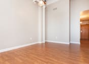 Thumbnail 37 of 58 - an empty living room with wood floors and white walls
